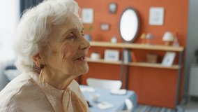 Happy elderly grandmother smiling, giving hugs and kisses to family members while greeting them before holiday dinner at home - Powered by Shutterstock - Get 15% off with code: PIKWIZARD15