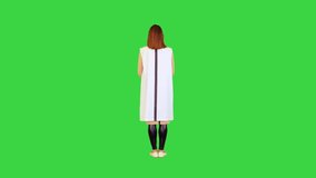 Cyber girl stands spreading her arms slowly on a Green Screen, Chroma Key.