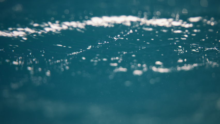 Water surface texture, Slow motion clean ocean ripples and wave, Refraction of sunlight top view texture sea side white sand, sun shine water background. Water Caustic Background. Light Rays Dark | Shutterstock HD Video #1090677597