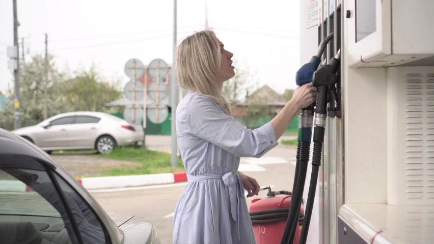 concept of rising gasoline prices. A man is dissatisfied with the high prices at a gas station Royalty-Free Stock Footage #1090678915