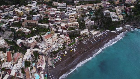Drone tilt-up reveals popular resort town of Positano on Amalfi Coast, Italy