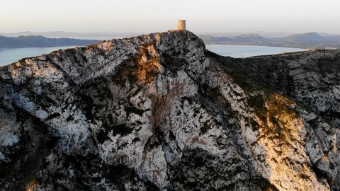 Drone flight over ancient Albercutx watchtower overlooking Bay of Pollensa