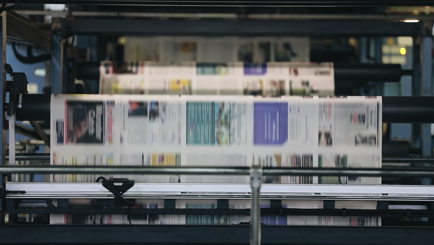 Images inked onto newspaper copies on a conveyor belt. The printing process of a weekly magazine with facilities of a copier shop. High quality FullHD footage