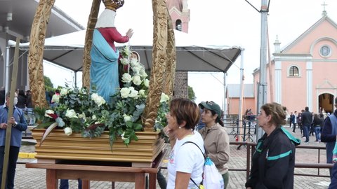 Farroupilha, Rio Grande do Sul, Brazil - 26th May, 2022: Pilgrims touching Our Lady of Caravaggio statue