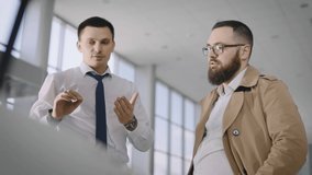 Sales manager and client near a new car with an open hood. The seller talks about the technical characteristics of the car. - Powered by Shutterstock - Get 15% off with code: PIKWIZARD15