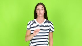 Young brunette woman doing stop sign over isolated background. Green screen chroma key