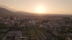 Fly above Sofia, Bulgaria at sunset 