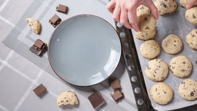 Woman puts fresh made homemade soft chocolate chip cookies from baking sheet to plate - Powered by Shutterstock - Get 15% off with code: PIKWIZARD15