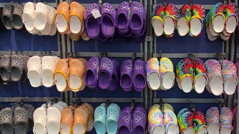 Springfield, IL USA - May 2, 2022: Panning down on rows of Crocs shoes at the Scheels Sporting Goods store in Springfield, Illinois.