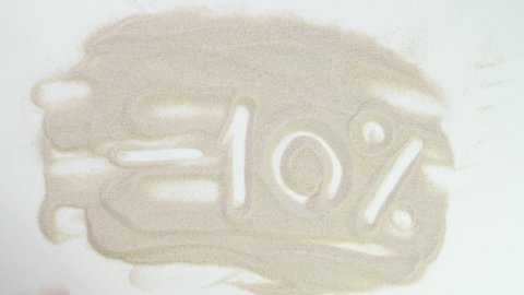 minus 10 percent off. sale and discounts. Top view draw on the sand. Caucasian hands write text in beige sand. Vacation and travel. Beach on vacation. Sand painting. Creativity from natural materials.