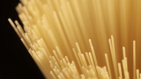Background Of Spaghetti Pasta. Uncooked Italian Pasta Golden Rotating Backdrop. Healthy Eating Concept. Raw Dried Organic Pasta. Long Macaroni, Rotating Background. Italian Culture - Powered by Shutterstock - Get 15% off with code: PIKWIZARD15