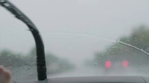 Car wipers that work during the rain. Focus on car glass