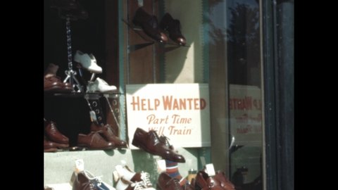1940s: Help Wanted Part Time sign in shop window. Shoe shop window. Man looks at job ad in window. Lady leaves shop. Work clapper board. Boy shales man’s hand. Hand removes job ad from window.