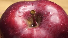 A large ripe apple of the red chief variety. Droplets of water on the peel of a red apple. Macro video with one fruit. A beautiful delicious apple. - Powered by Shutterstock - Get 15% off with code: PIKWIZARD15