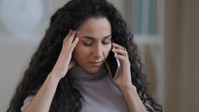 Worried arabic hispanic woman young girl student businesswoman talking mobile phone sit at home disappointed female freelancer receiving bad news misunderstanding problem has headache negative emotion - Powered by Shutterstock - Get 15% off with code: PIKWIZARD15