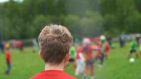Boys soccer players playing football game. Back view of goalkeeper. - Powered by Shutterstock - Get 15% off with code: PIKWIZARD15