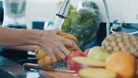 Pregnant diet. Pregnant woman washes fruits and prepares healthy cocktail on the modern kitchen - Powered by Shutterstock - Get 15% off with code: PIKWIZARD15