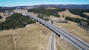Old road and new highway from Krakow to Zakopane in Poland, called Zakopianka with viaducts, elevated crossroads and cars. Aerial 4K video