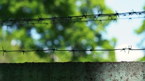 fence with barbed wire.4k frames with barbed wire symbolizing the restricted area for outsiders