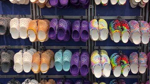 Springfield, IL USA - May 2, 2022: Zooming out on rows of Crocs shoes at the Scheels Sporting Goods store in Springfield, Illinois.