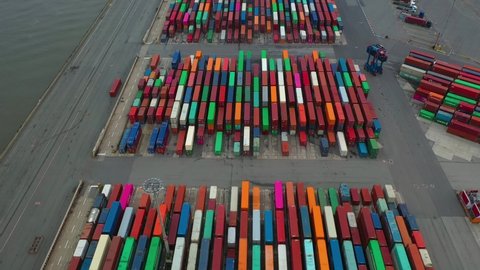 Drone shot of modern industrial port of Hamburg with containers from top view or aerial view. It is an import and export cargo port where is a part of shipping dock