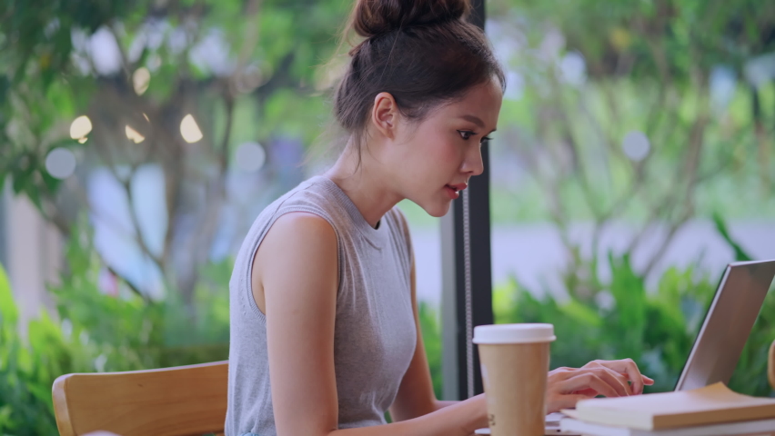 digital nomad millennial gen x lifestyle,asian female freelance casual working from cafe working anywhere work while vacation smiling hand type laptop cheerful positive thinking work remotely in cafe Royalty-Free Stock Footage #1090731051