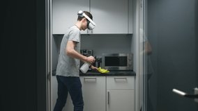 Young man in vr headset clean office kitchen with detergent spray and cloth.  - Powered by Shutterstock - Get 15% off with code: PIKWIZARD15