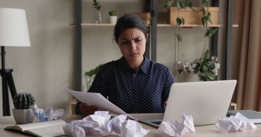 Angry confused young Indian office employee clerical worker sort out documents feels enraged lost patience throwing crumpled papers having nervous breakdown at work, deadline business problems concept Royalty-Free Stock Footage #1090734465