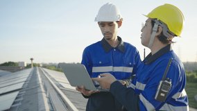 Two Asian technician installing inspection or repair solar cell panels on background field of photovoltaic solar panels solar cells on roof top factory. - Powered by Shutterstock - Get 15% off with code: PIKWIZARD15