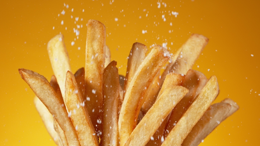 Super Slow Motion Detail Shot of adding Salt on Fresh French Fries at 1000fps. Royalty-Free Stock Footage #1090736899