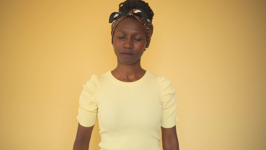 young woman comparing printed books to e-book while an e-book on her right hand while smilling at printed book on her left hand 
