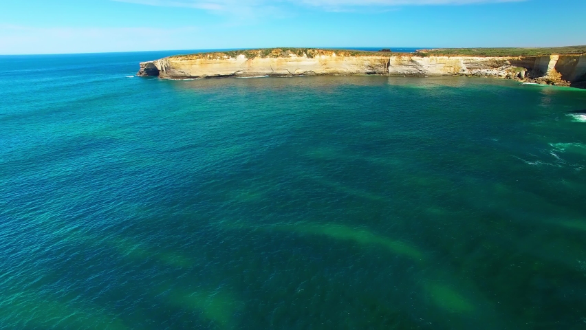 The Arch rock formation along the Great Ocean Road, Victoria - Australia. Aerial view on a sunny morning. Slow motion.