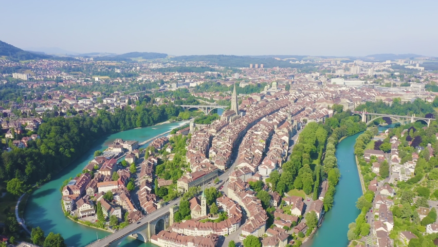 Inscription on video. Bern, Switzerland. Historic city center, general view, Aare river. Multicolored text appears and disappears, Aerial View