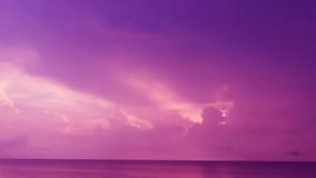 Dramatic thunder rain storm cloud n Pastel purple pink cloudscape on Sunset blue sky over red sea water n calm ocean wave in tropical summer sunlight n sun ray, 4k b-roll TimeLapse footage video 