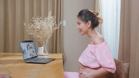 Asian young pregnant woman talking virtual online with medical doctor. Attractive physician man giving telehealth telemedicine video call for internet consult diagnosis treatment to female pregnancy.