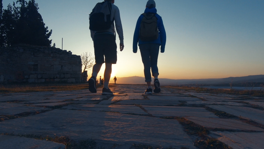 Couple walking towards sunset at Pammukale, Turkey