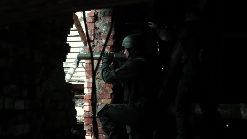 A soldier fires a grenade launcher. A shot from an RPG.