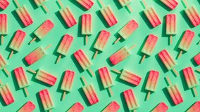 Vibrant, multicolored popsicles on a rainbow background. Frozen snack on a stick perfect for summer refreshment during hot days. Seamless looping animation of ice pops. Homemade watermelon flavour - Powered by Shutterstock - Get 15% off with code: PIKWIZARD15