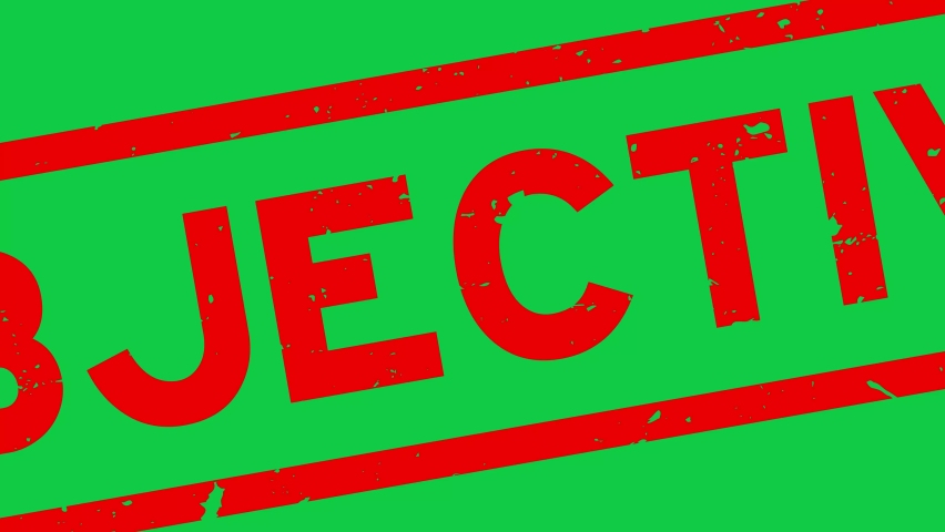 Grunge red objective word rubber stamp zoom on green background