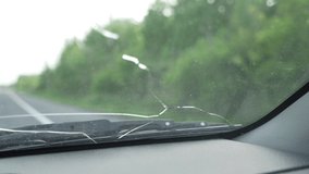 Driving a car with a cracked windsheld. Closeup shot of the crack while driving the vehicle on the road. - Powered by Shutterstock - Get 15% off with code: PIKWIZARD15