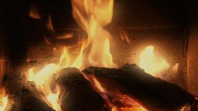 Fireplace with Relaxing Flames. A medium sized fireplace which is very relaxing with almost horizontal logs and a gentle but full flame. Filmed in high definition close up to emphasise the flames.
