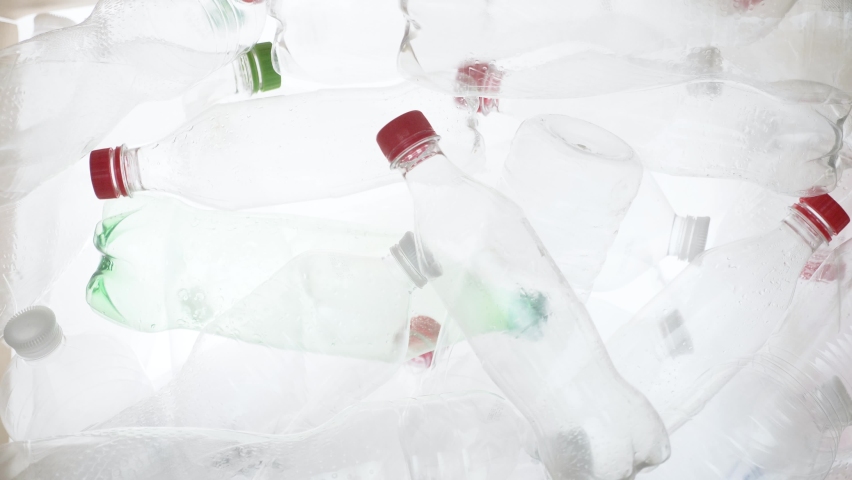 Empty plastic bottles falling down. Water PET bottle recycling plastic water bottle recyclable waste sorting. Recyclable trash recycle garbage bottles background plastic PET recycling waste processing Royalty-Free Stock Footage #1090775687
