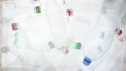 Empty plastic bottles falling down. Water PET bottle recycling plastic water bottle recyclable waste sorting. Recyclable trash recycle garbage bottles background plastic PET recycling waste processing