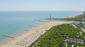 Inscription on video. Italy, Jesolo. Light House Faro di Piave Vecchia. Lido di Jesolo, is the beach area of the city of Jesolo in the province of Venice. Appears from the sand, Aerial View, Point of