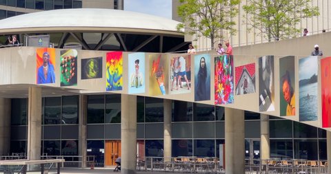 Toronto, Canada - May 29, 2022: Shine On, an exhibit of photographs from the BIPOC photo mentorship program. They are seen in the exterior walls of the New City Hall in Nathan Phillips Square