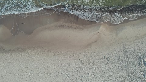 Top view beach with bright sand at sunrise.