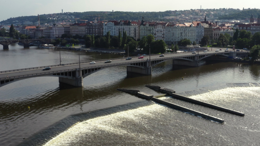 Prague Jirásek bridge over Vltava river with weir and sluice, drone.
