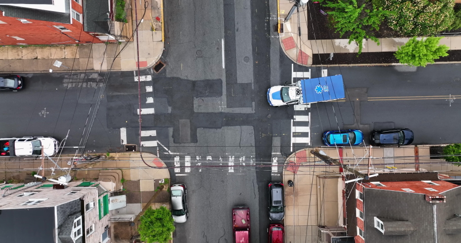 Top down view of ambulance on city street. Emergency vehicle drives down road on spring day.