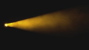 Yellow spot light that projects a beam of light on smoke that loops infinitely, the background is black - Powered by Shutterstock - Get 15% off with code: PIKWIZARD15