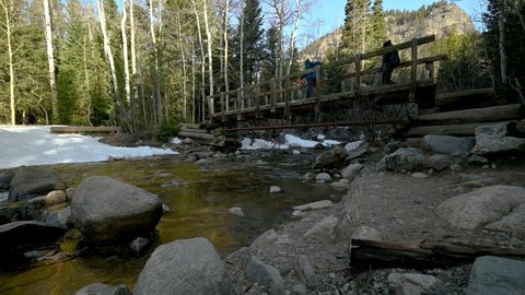 Hiking across a bridge over a North Fork Boulder Creek, Nederland, Colorado